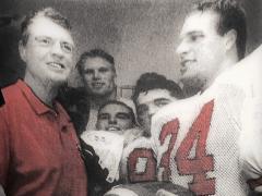 Trev Alberts presents the game ball to Tom Osborne